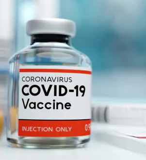 Foto di una fiala con scritta: Covid-19 Vaccine